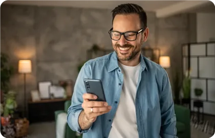 Man looking at his mobile phone and smiling